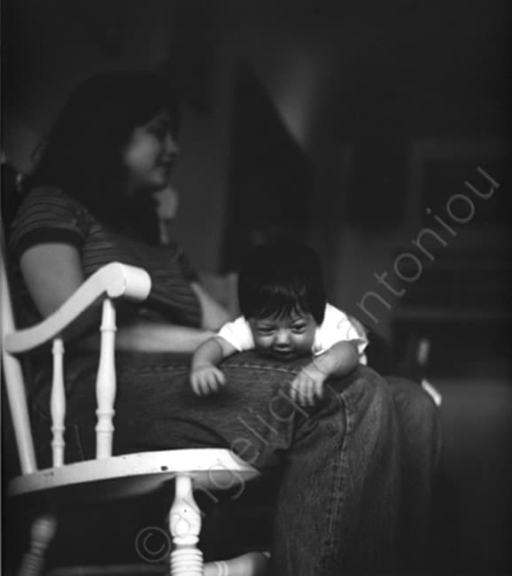 Black and white children photograph titled Lap Time by Angelique Antoniou