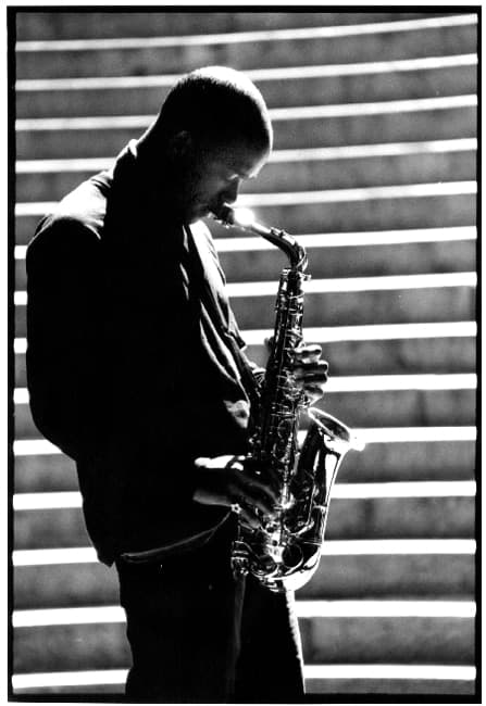 Black and white people photograph titled Sax Solo by Angelique Antoniou