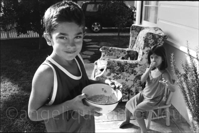 Black and white children photograph titled The Cereal by Angelique Antoniou